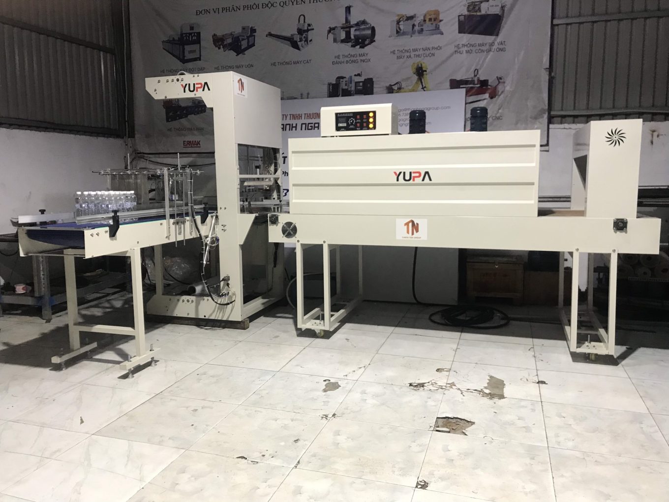 Máy co màng lốc chai lon nước tự động
